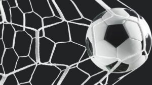 A soccer ball flies into a net