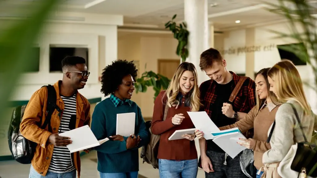 Group of five high school students compare test scores